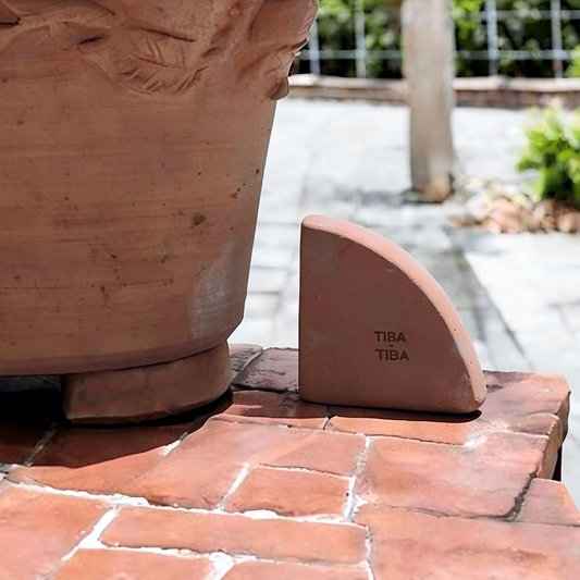 Po-Ka Pot feet by TIBA-TIBA - terracotta pot foot with an outdoor terracotta planter in an Italian garden.