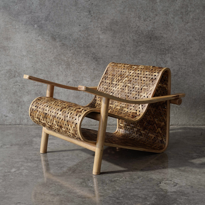 Koo-Boo Lounge Chair by TIBA-TIBA – modern bamboo lounge chair with woven bamboo mesh seat and laminated bamboo arms on polished concrete floor with concrete wall background. 