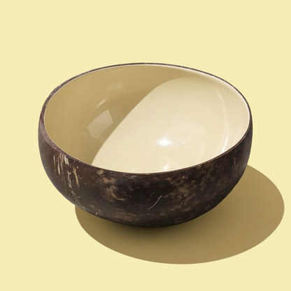 Dots Coloured Coconut Bowls by TIBA-TIBA – Banana yellow coloured coconut bowl on pale yellow background. Food-safe tropical breakfast smoothie bowl.