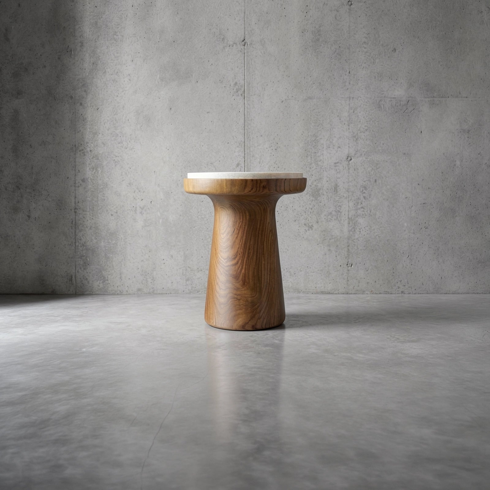 Cono - a sculptural teak and white marble top side table by TIBA-TIBA in a concrete space