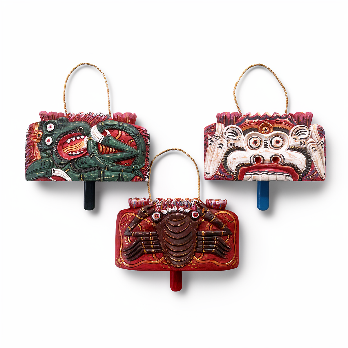 Lonceng Sapi Cowbell by TIBA-TIBA – 
Front view of set of three Solid Mahogany hand-carved Bali cowbells with Dragon, Monkey, and Crab motif.