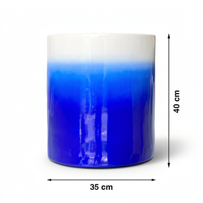 Fade Cylinder planter by TIBA-TIBA – Dark blue ceramic plant pot with a glossy, glazed gradient finish that fades to white at the top. 