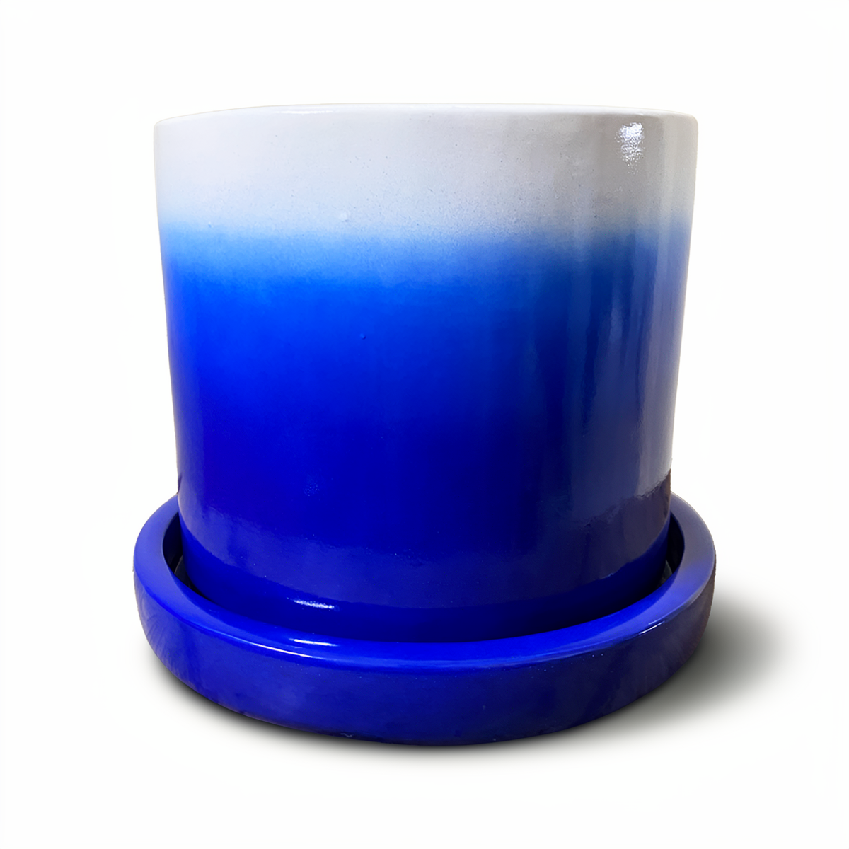 Tatakan plant saucer by TIBA-TIBA – dark blue high-gloss glazed ceramic planter drip tray under dark blue Fade Pot. 