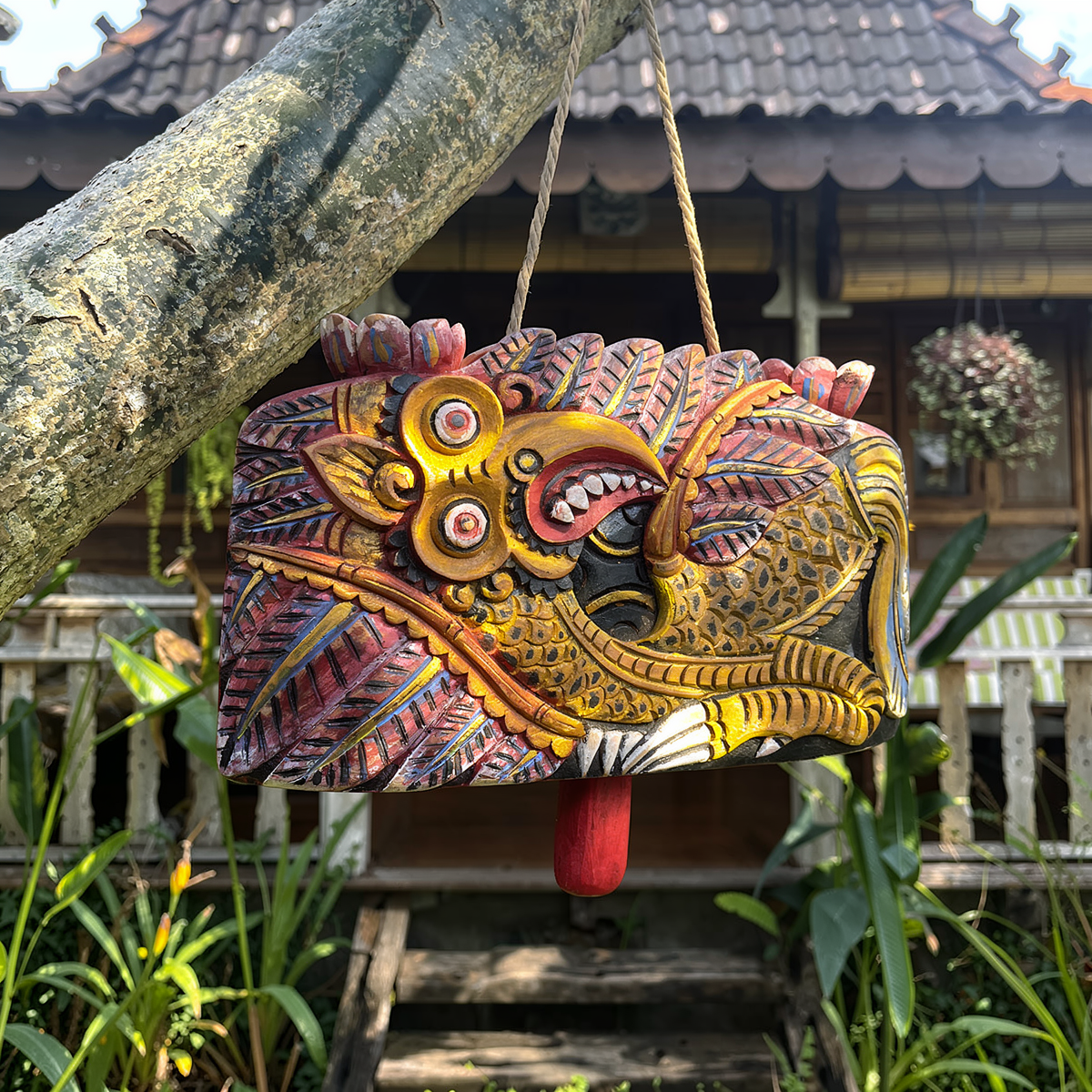 Lonceng Sapi Cowbell by TIBA-TIBA – 
Solid Mahogany hand-carved Bali cowbell with Garuda motif hanging outside a Balinese Joglo. 