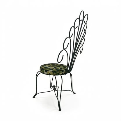 Plume Chair by TIBA-TIBA – powder-coated dark green peacock chair with curved metal frame and green patterned QDF cushion, rear angle view. 