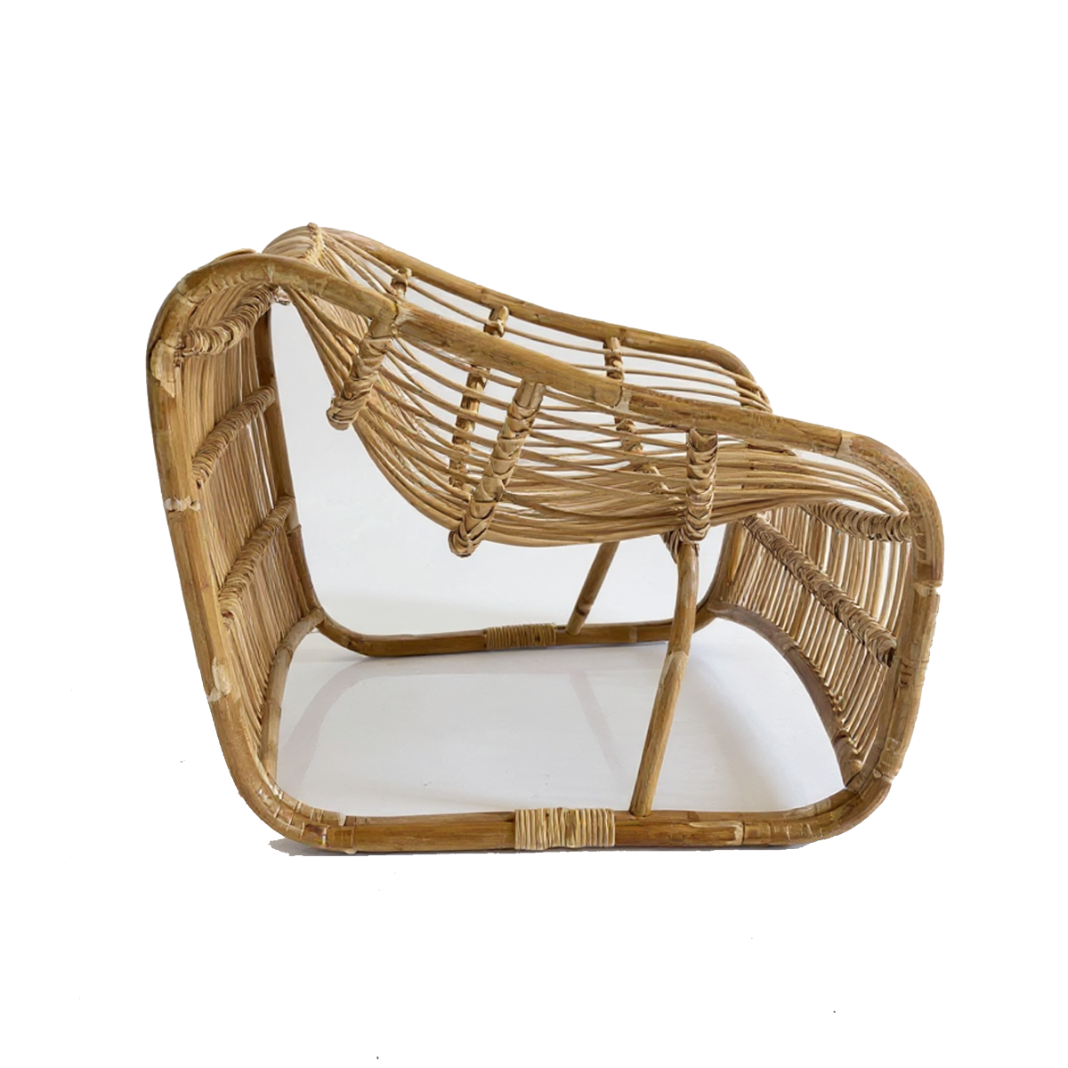 Bucket Lounge Chair by TIBA-TIBA – handwoven natural rattan lounge chair with soft curves and low modern silhouette, crafted in Indonesia for relaxed tropical living.