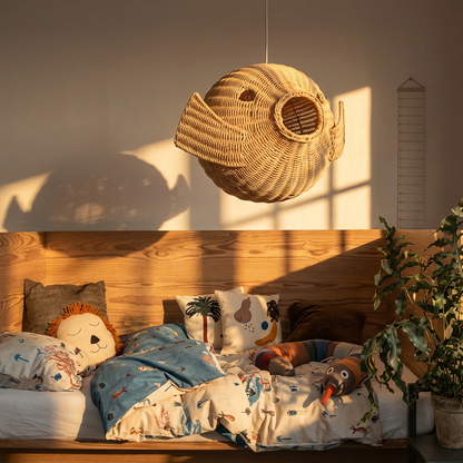 Ikan 40 Rattan Pendant Light by TIBA-TIBA - rattan puffer fish pendant lamp hanging above kid's cozy wooden framed bed filled with pillows and plush snake.  
