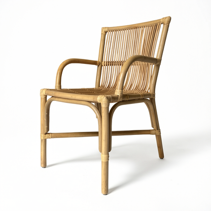 Ro-Di-O Dining Chair by TIBA-TIBA – Handcrafted natural wicker dining chair with arms, rattan seat, minimalist frame. Angled view. 
