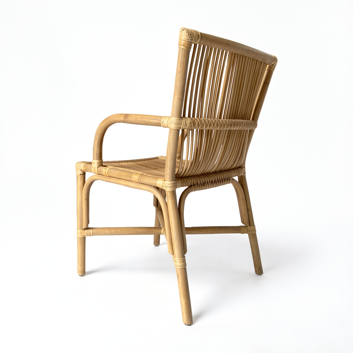 Ro-Di-O Dining Chair by TIBA-TIBA –  Indonesian natural rattan dining chair with arms and minimalist frame angled rear perspective view.
