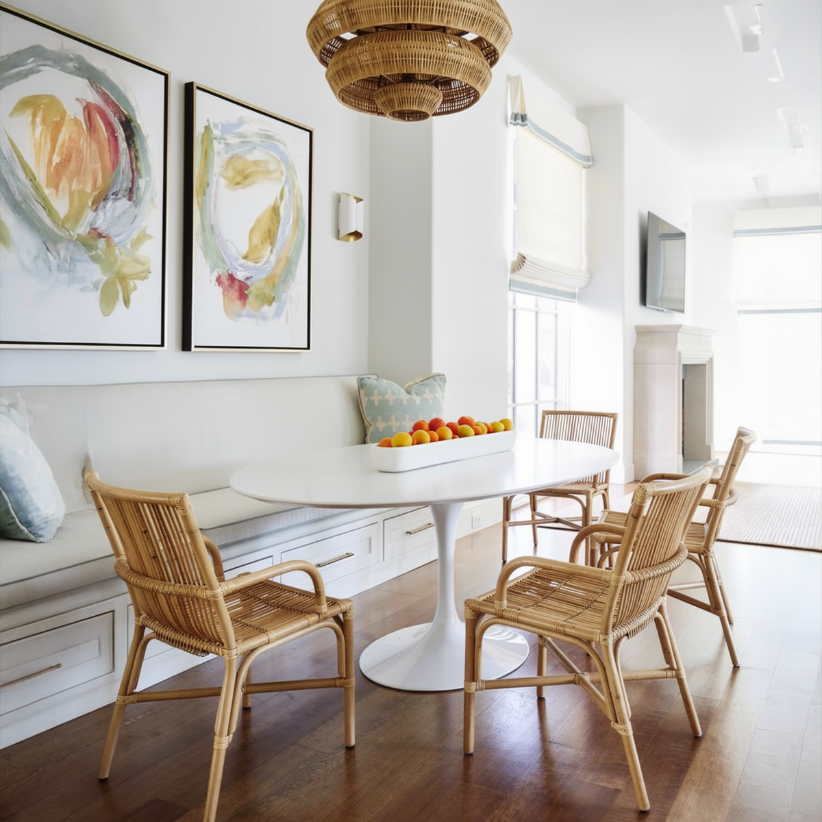 Ro-Di-O Dining Chair by TIBA-TIBA – White modern living area with Tulip dining table, long padded dining bench and 4 wicker dining chairs with arms.