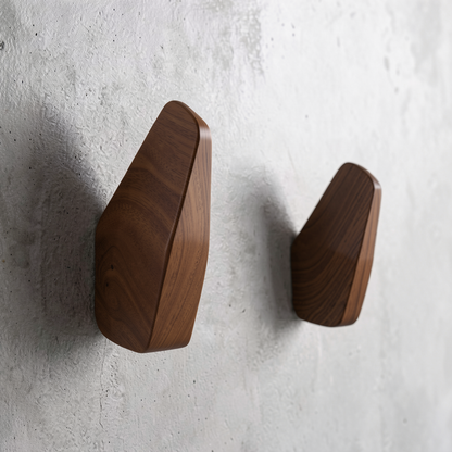Fin Wall Hook by TIBA-TIBA - Two minimalist wooden fin wall hooks mounted on a concrete wall.