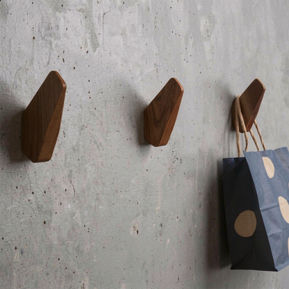 Fin Wall Hook by TIBA-TIBA - Three artistic wooden airplane fin wall hooks mounted on a concrete wall with blue polkadot bag hanging from one hook.  