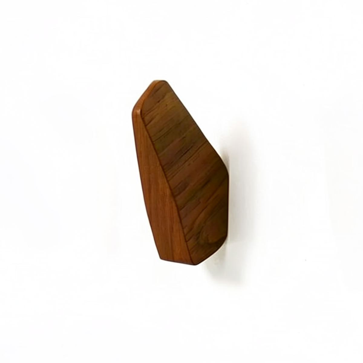 Fin Wall Hook by TIBA-TIBA -  Minimalist teak wall hook mounted on a white wall. 