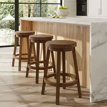 Three Sixty Stools by TIBA-TIBA – three teak wood counter stools with rotating seats at white marble kitchen counter with light wood interior panelling.  