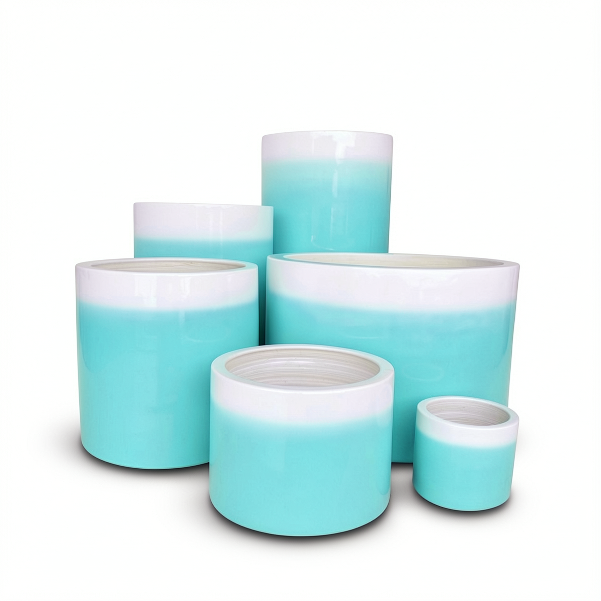 Fade Cylinder planters by TIBA-TIBA – Group of six glossy turquoise ombre ceramic pots of varying sizes.