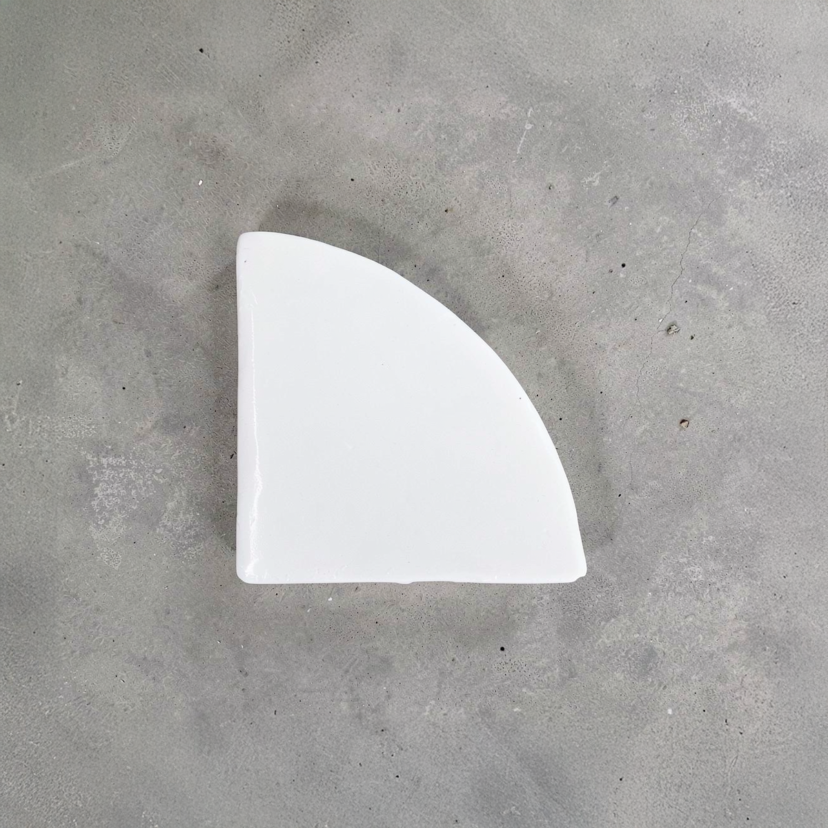 Po-Ka Pot feet by TIBA-TIBA - detail of white glazed ceramic pot foot for planter drainage and airflow on concrete background. 