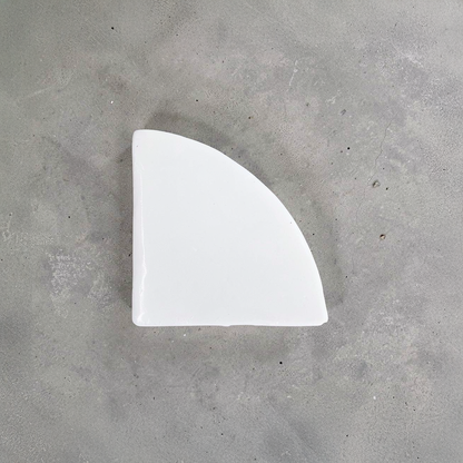Po-Ka Pot feet by TIBA-TIBA - detail of white glazed ceramic pot foot for planter drainage and airflow on concrete background. 
