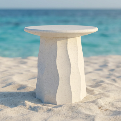 Jetty Side Table by TIBA-TIBA - white terrazzo outdoor side table with vertical wave motif in sand at tropical beach. 