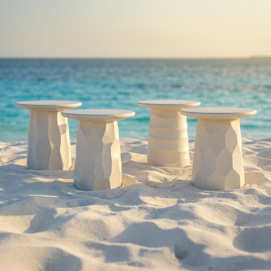 Jetty Side Table by TIBA-TIBA, close up of white terrazzo side table with white sofa, blue patterned pillows on a wooden deck by the water.