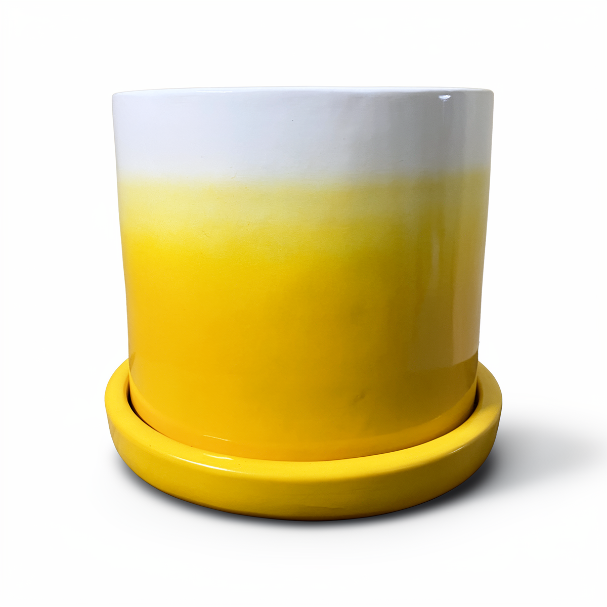 Tatakan plant saucer by TIBA-TIBA – yellow high-gloss glazed terracotta pot drip tray under yellow Fade Pot. 